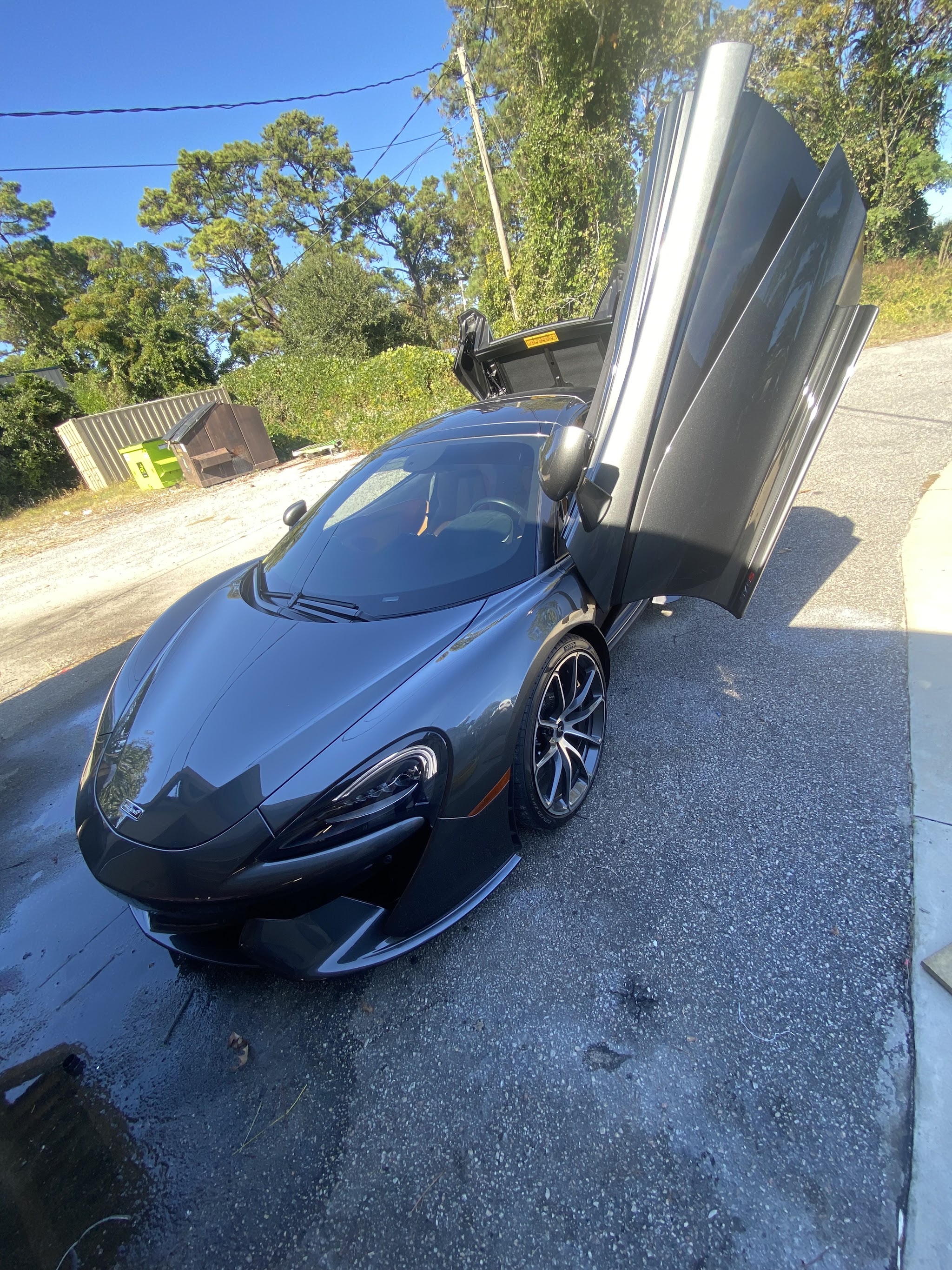 Grey McLaren with its doors raised